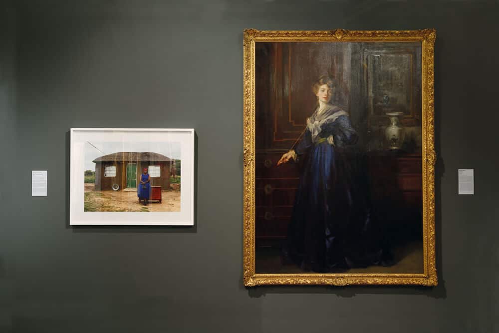 Installation view: ‘Our Lady’, IZIKO SANG, 2016. Pictured left: Zwelethu Mthethwa, Untitled (from Hope Chest series) 2012, Chromogenic Print, The New Church Museum Collection. Right: George Henry, The Blue Gown, Undated, Oil on canvas, ISANG Collection. Photograph: Candice Allison. Image courtesy of The New Church Museum.