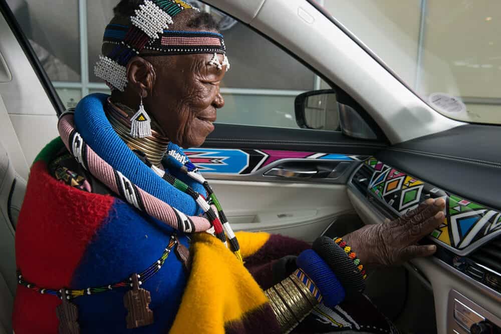Esther Mahlangu admiring her painting in the BMW 525i Sedan. Courtesy of AG BMW.