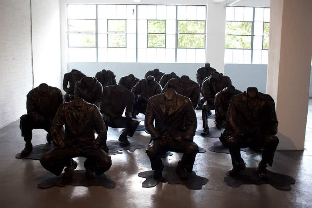 Haroon Gunn-Salie, Senzenina, 2018. Sculptural installation with sound element, 17 life-size crouching figures. Each Figure: 27.6 x 39.4cm. Courtesy of the artist & Goodman Gallery.