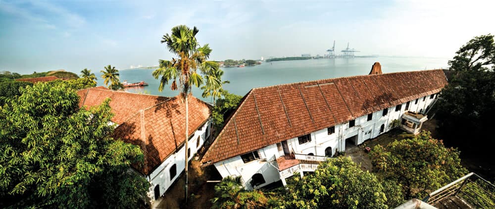 Aspinwall House is a large sea-facing heritage property in Fort Kochi. The property was originally the business premises of Aspinwall & Company Ltd. established in 1867 by English trader John H Aspinwall. Under the guidance of Aspinwall the Company traded in coconut oil, pepper, timber, lemon grass oil, ginger, turmeric, spices, hides and later in coir, coffee, tea and rubber. The large compound contains office buildings, a residential bungalow and a number of warehouses and smaller outer-lying structures. Aspinwall House is the primary venue of the Biennale, hosting numerous artist led projects and events spaces.