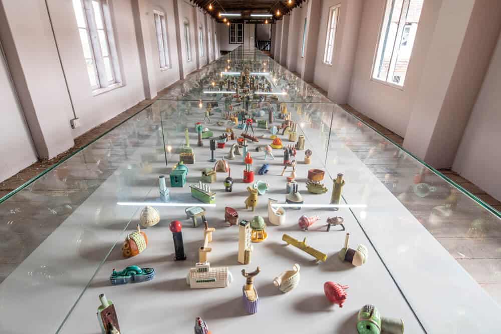 Lubna Chowdhury, ‘Metropolis’, Installation view at Kochi-Muziris Biennale 2018, Courtesy of Kochi Biennale Foundation. This multi-object work consists of over a thousand handmade clay sculptures presented in display cases. Lubna Chowdhury began Metropolis in 1991 and didn’t complete the installation of 1000 ceramic sculptures until 2017, when she first exhibited the work in its entirety at the Victoria and Albert Museum in London.