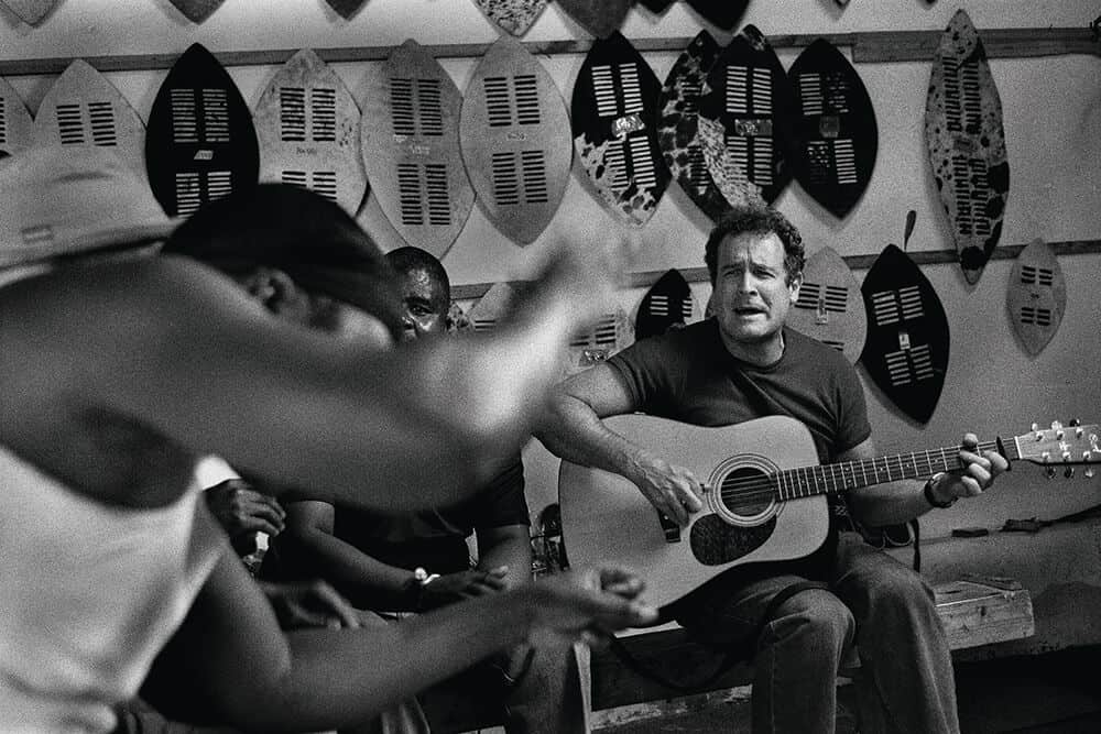 Johnny plays the guitar in the highly sophisticated traditional Zulu picking style. © Patrick de Mervelec