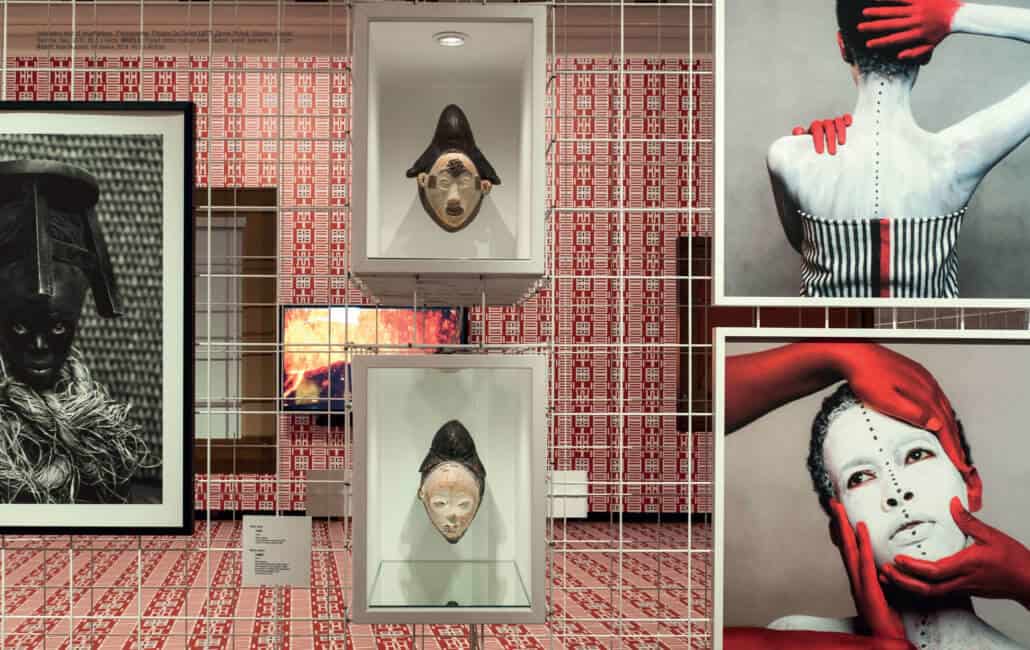 Installation shot of ‘incarNations’. Photographer: Philippe De Gobert LEFT: Zanele Muholi, Sibusiso, Cagliari, Sardinia, Italy, 2015, 69,5 x 94cm. MIDDLE: Punu/Lumbu mukuyi mask, Gabon, wood, pigments, H. 35cm. RIGHT: Aida Muluneh, 99 Series, 2014. 90,5 x 90,5cm.